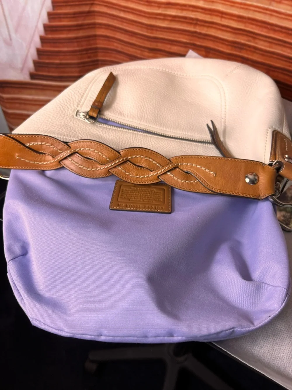 Coach Soho White Pebbled Leather Hobo bag features a distinctive braided handle